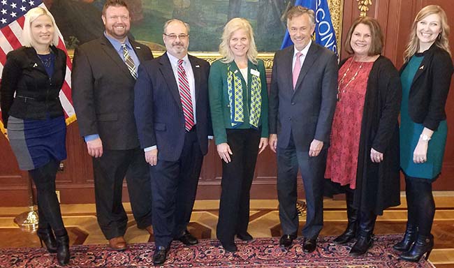 Credit union representatives attended the signing of the bill requiring financial education Credit union representatives attended the signing of the bill requiring financial education